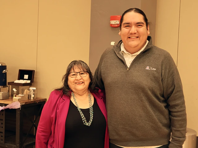 Joan Timeche and Damon Clark pose at Joan's retirement party