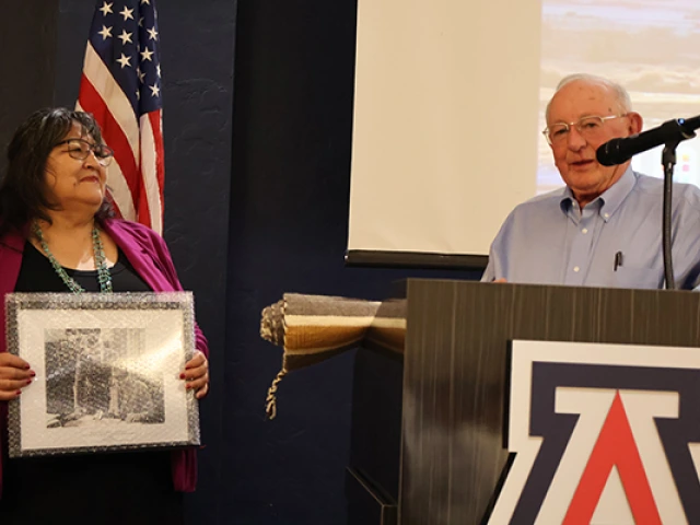 Joan receives an award for her service from Eric Eberhard and the Udall Foundation