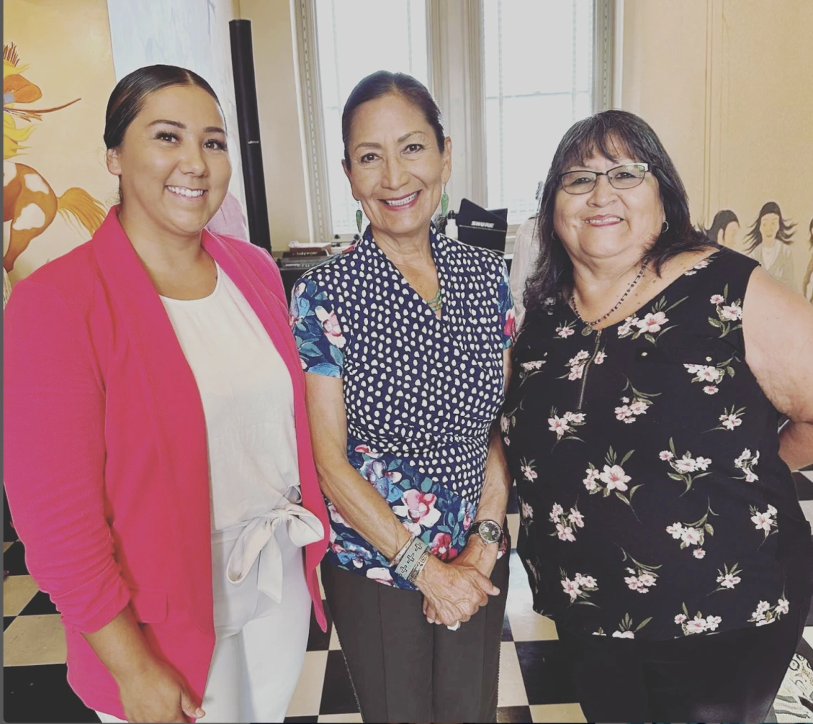 Crystal Miller and Joan Timeche pose with Secretary of the Interior Deb Haaland in Washington, D.C.