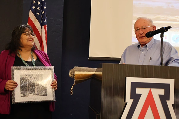 Joan receives an award for her service from Eric Eberhard and the Udall Foundation